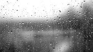 black and white image of rain on glass