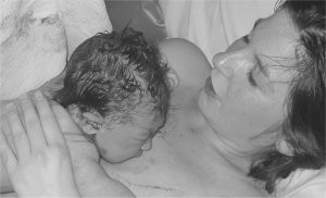 Image of Jay holding her newborn for the first time