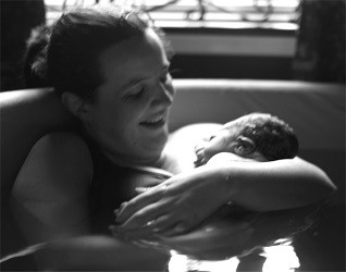 Image of Jenna in pool with her newborn