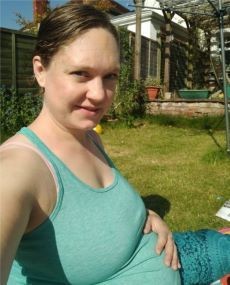 Pregnant Rosie West in her garden