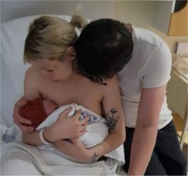 Leanne and her husband hold newborn baby