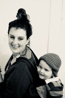 Sophie Martin black and white photo - wearing baby on her back