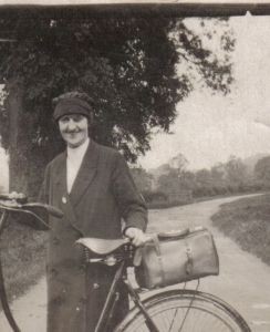 District midwife just before the Second World War showing uniform and transport